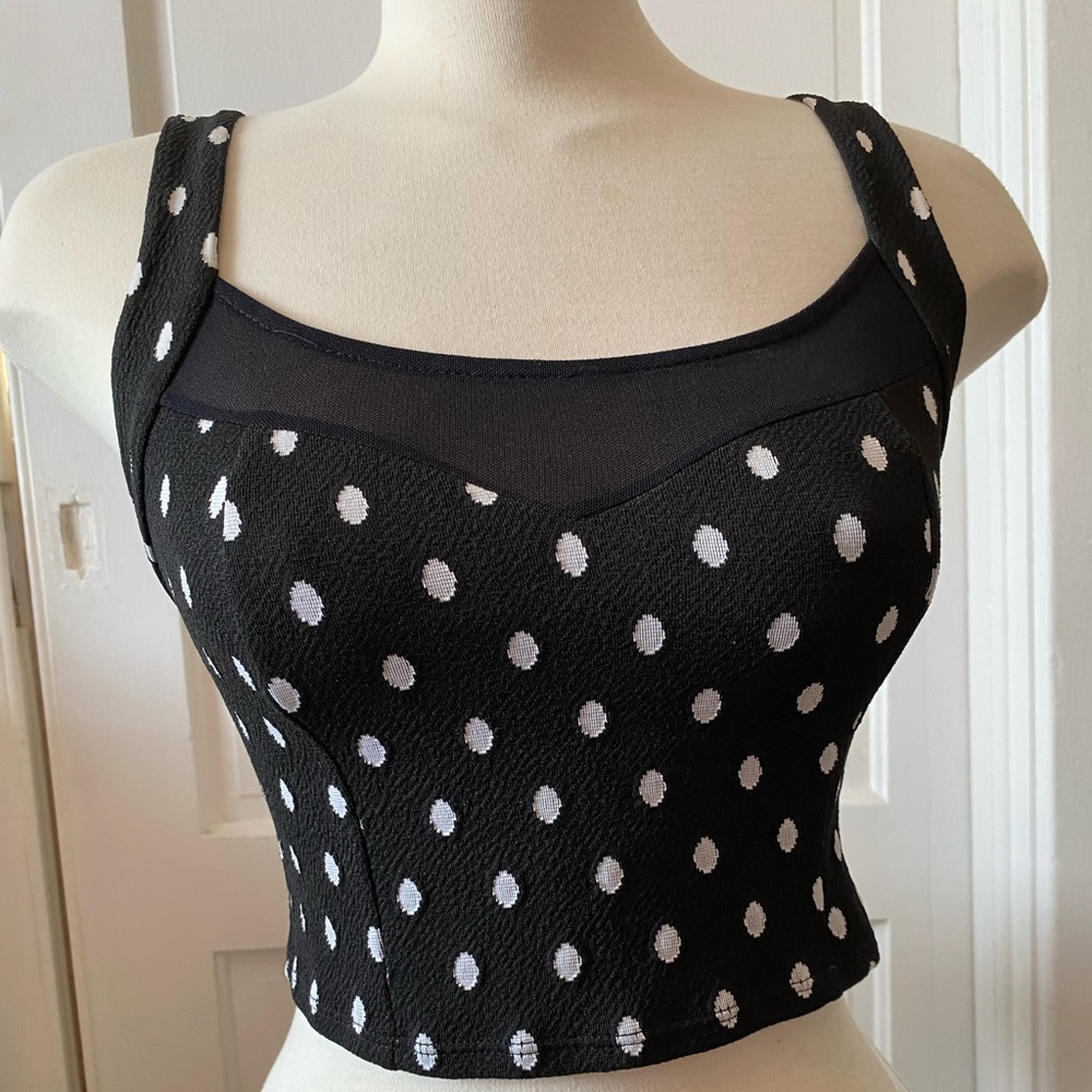 Black and white polka dot cropped camisole with mesh details. Size M.